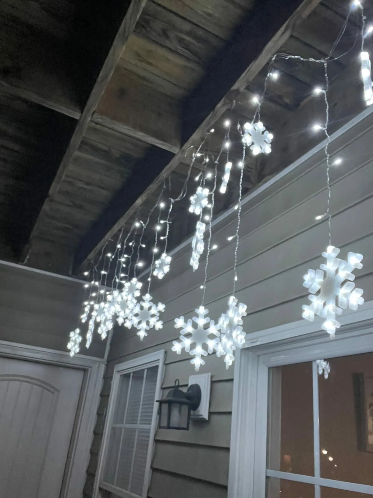 White Stringlights Hanging Wooden Ceiling Side Angle View Snowflake Christmas Lights